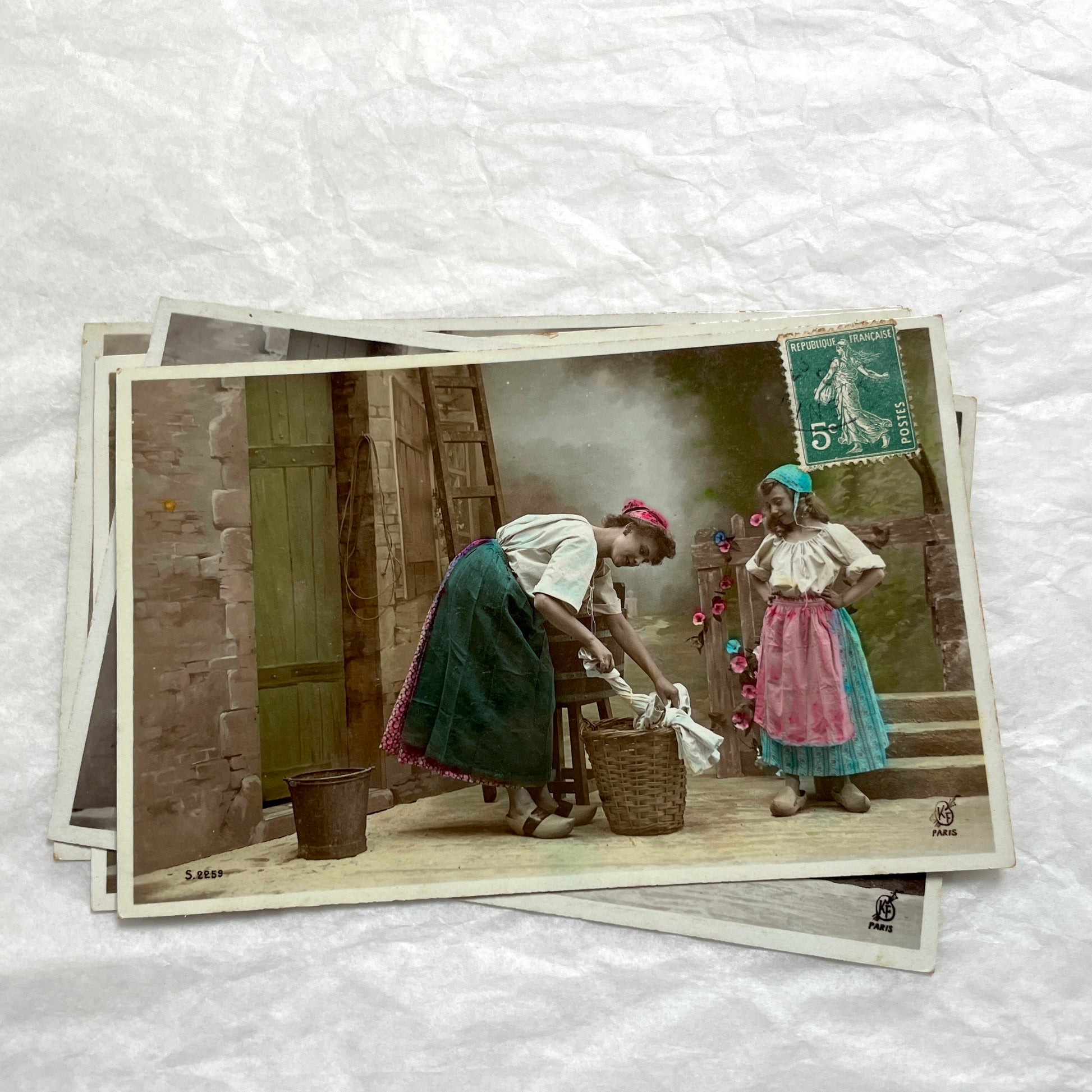 Lot of 6 1910s French postcards depicting women washing laundry in a village setting with visible French stamps.