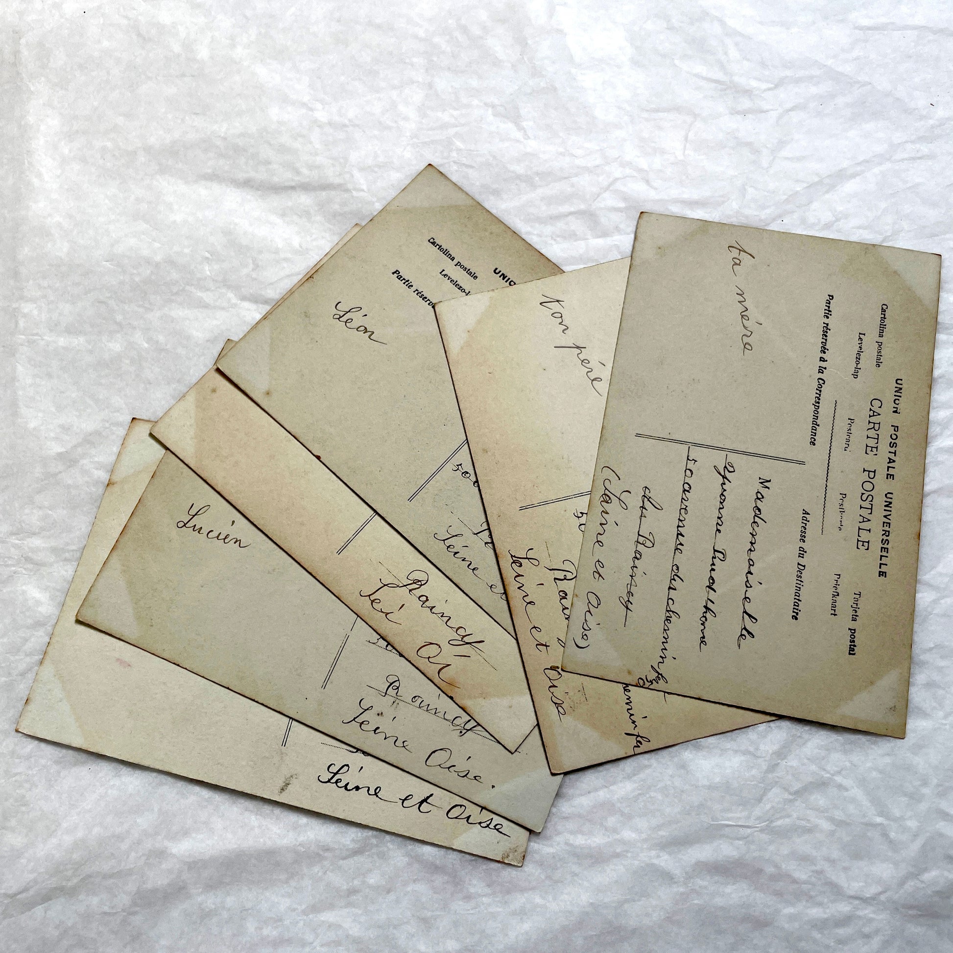 Lot of 6 1910s French postcards depicting women washing laundry in a village setting with visible French stamps.