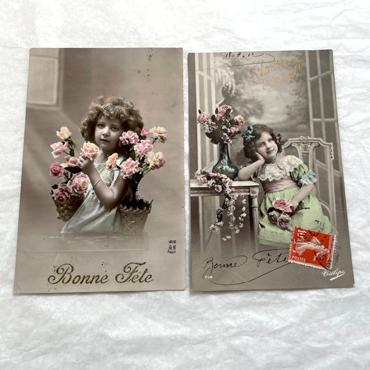Two French postcards from the 1910s depicting young girls with flowers and 'Bonne Fete' greetings.