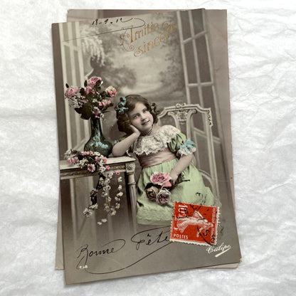 Two French postcards from the 1910s depicting young girls with flowers and 'Bonne Fete' greetings.