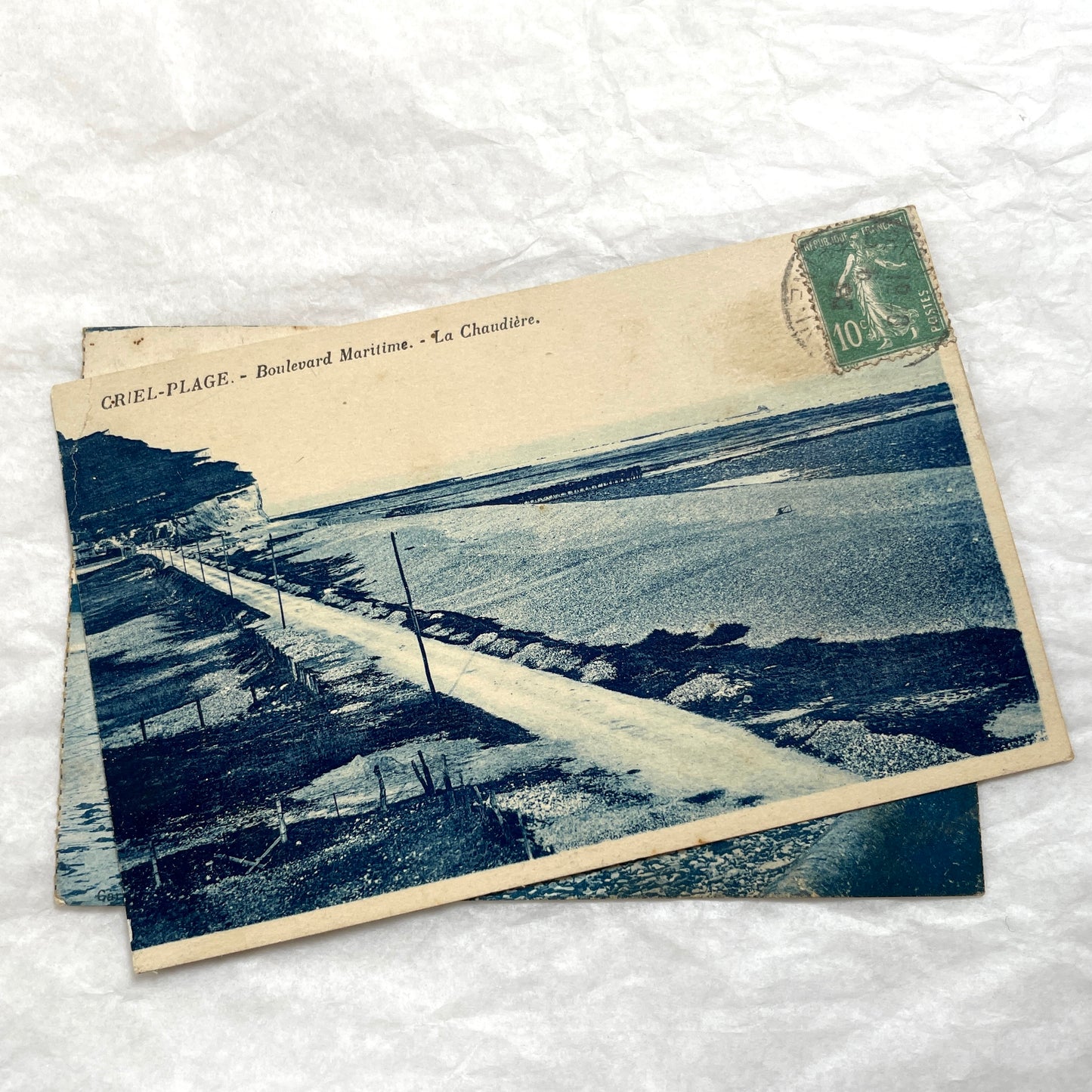 Two 1910s vintage French postcards featuring coastal scenes with beaches, seaside buildings, and dramatic cliffs.