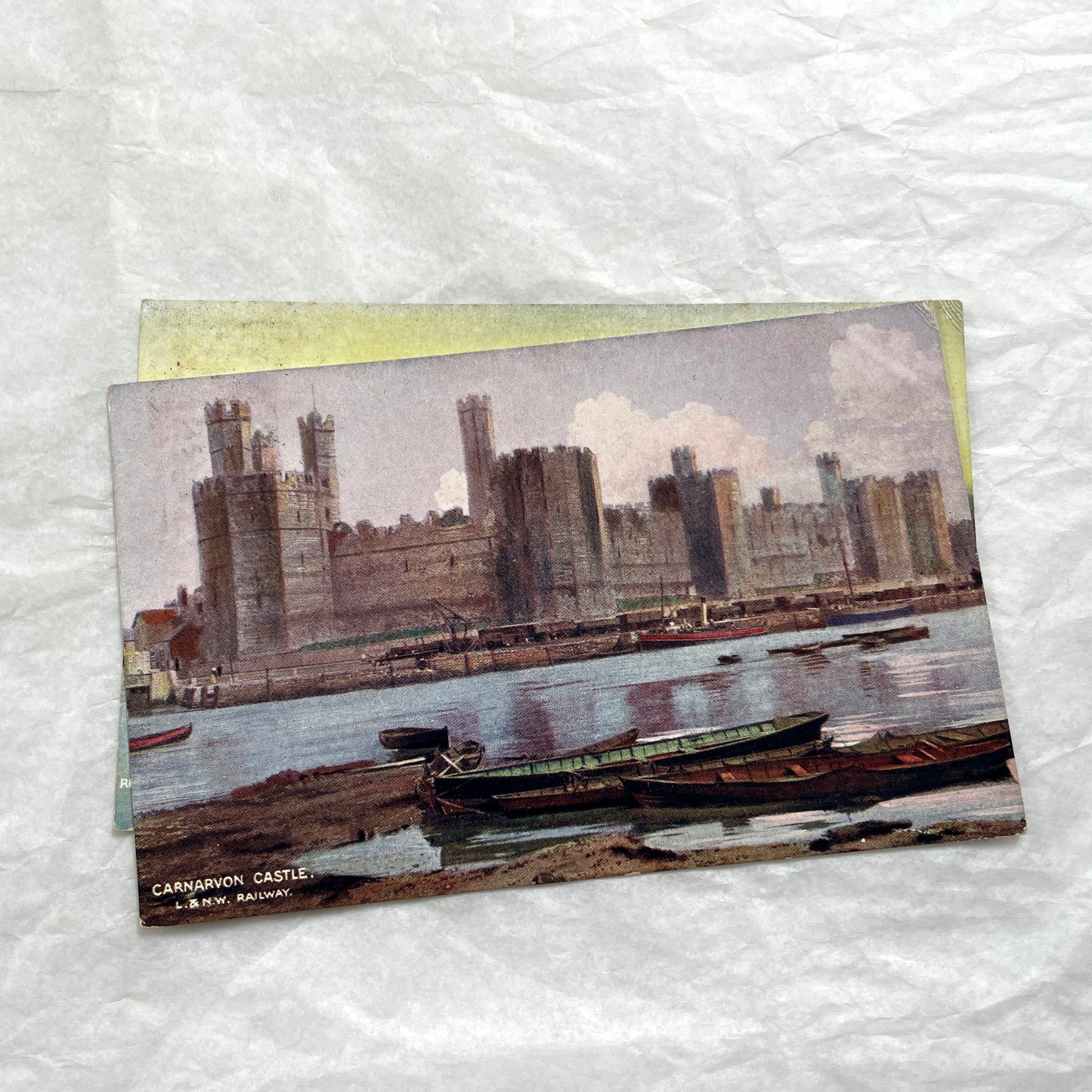 1910s postcard lot featuring European castles, a Swiss waterfall, and an English harbor scene with boats.