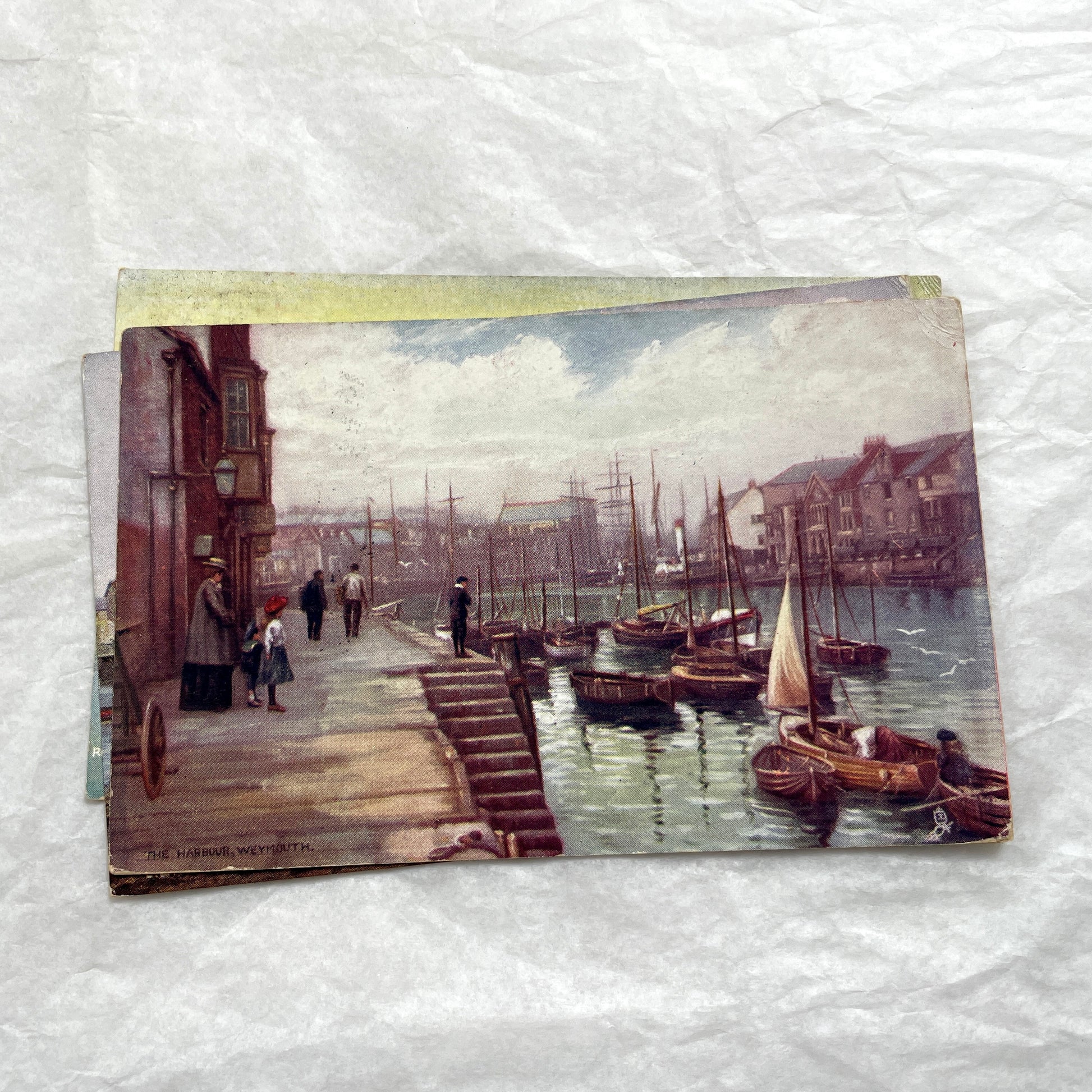 1910s postcard lot featuring European castles, a Swiss waterfall, and an English harbor scene with boats.