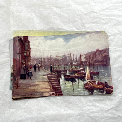 1910s postcard lot featuring European castles, a Swiss waterfall, and an English harbor scene with boats.