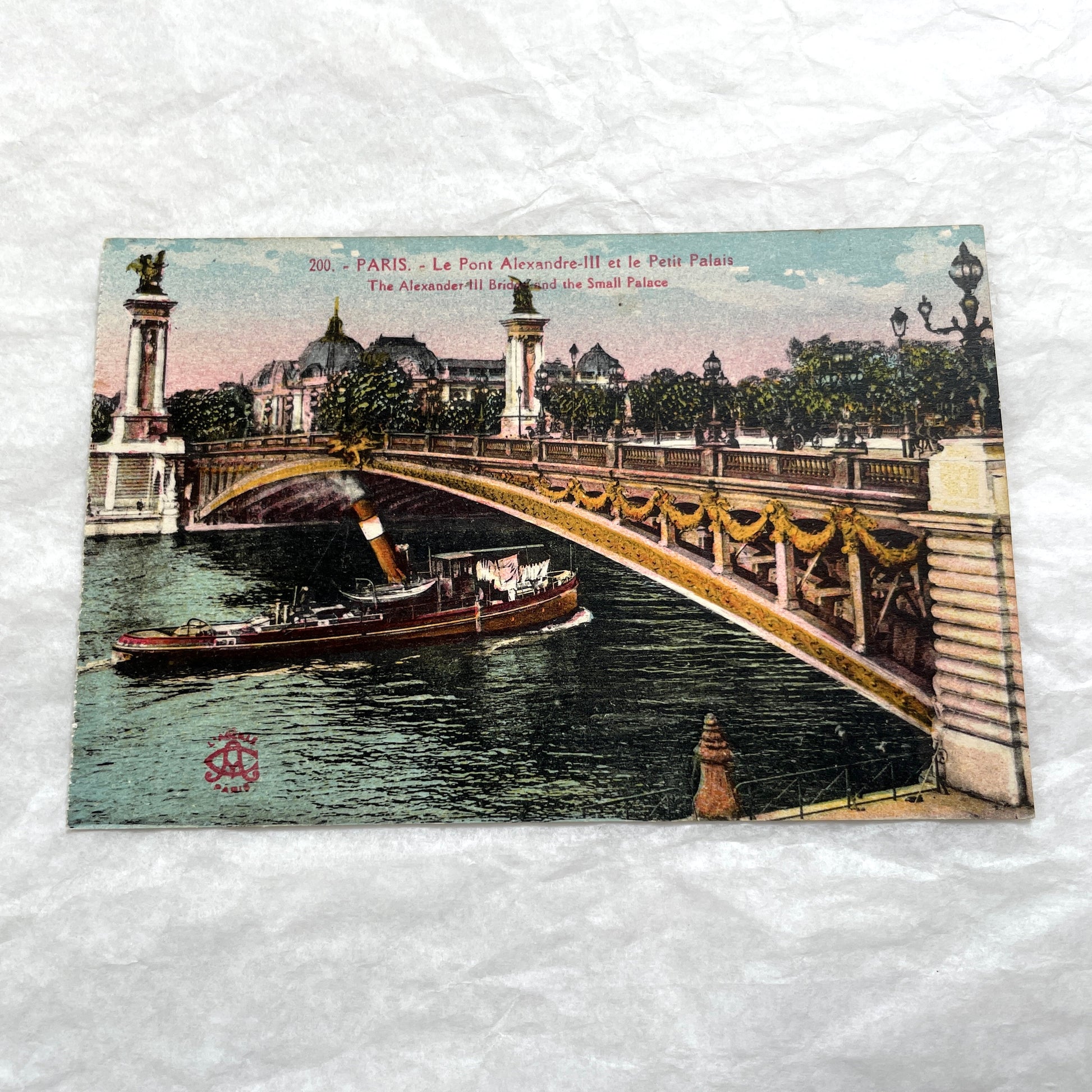 1900s vintage Paris postcards showing Pont Alexandre III and Conciergerie with boats on the Seine River.
