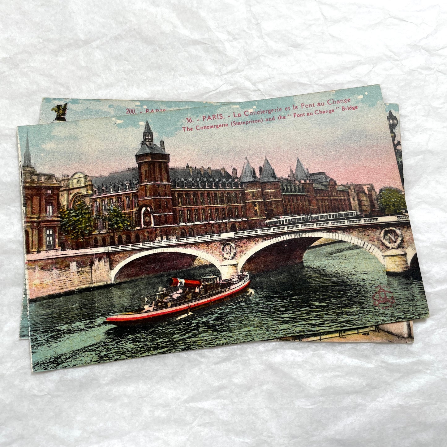 1900s vintage Paris postcards showing Pont Alexandre III and Conciergerie with boats on the Seine River.