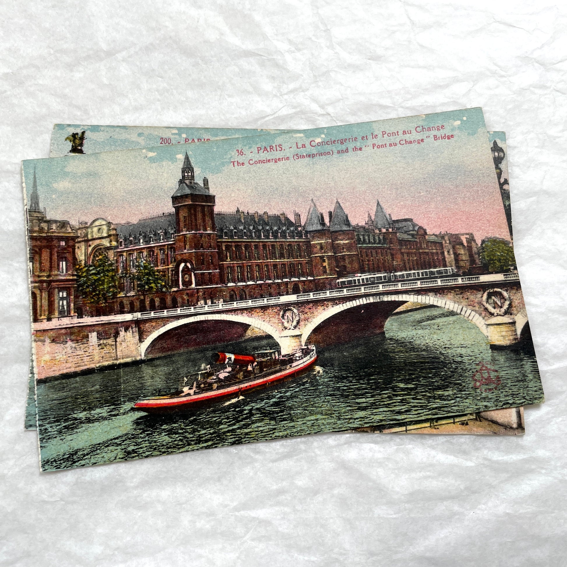 1900s vintage Paris postcards showing Pont Alexandre III and Conciergerie with boats on the Seine River.