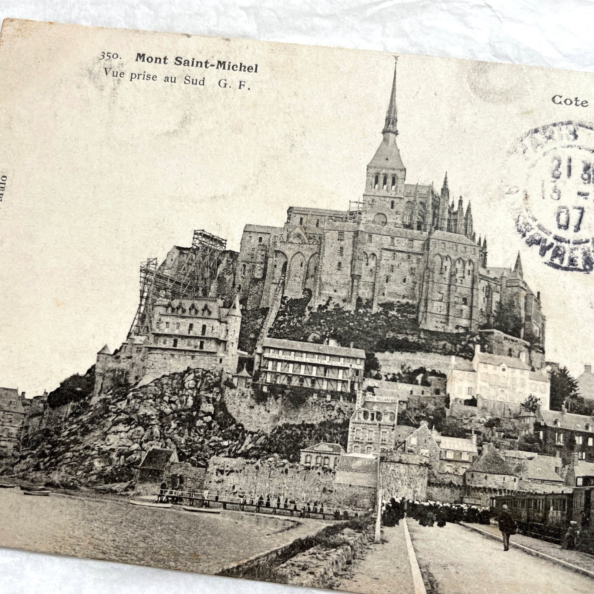 1900s postcard of Mont Saint-Michel abbey in France, showing its majestic medieval architecture and surrounding village.