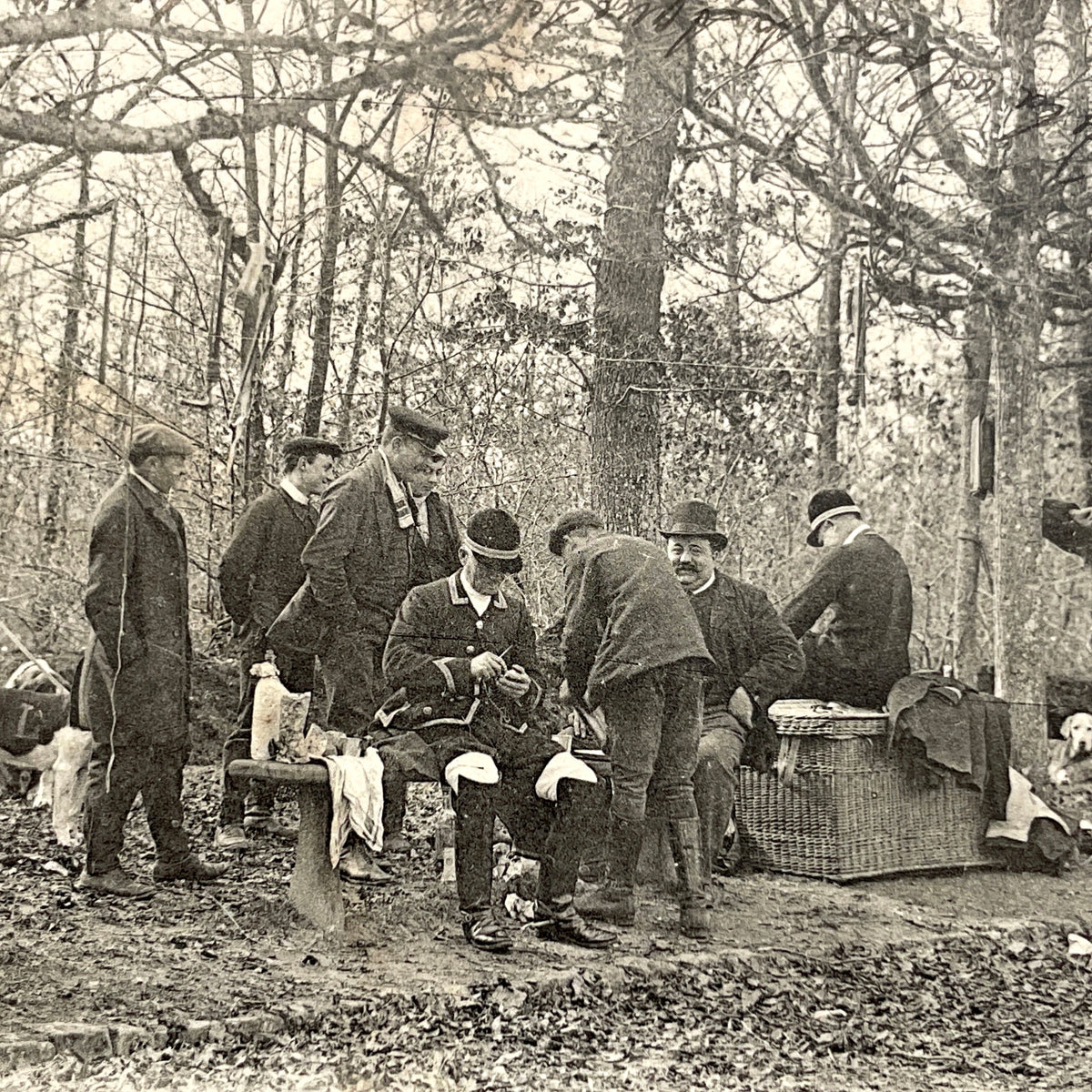 1900s French postcard showing huntsmen and a vintage bicycle having a picnic in Fontainebleau Forest.