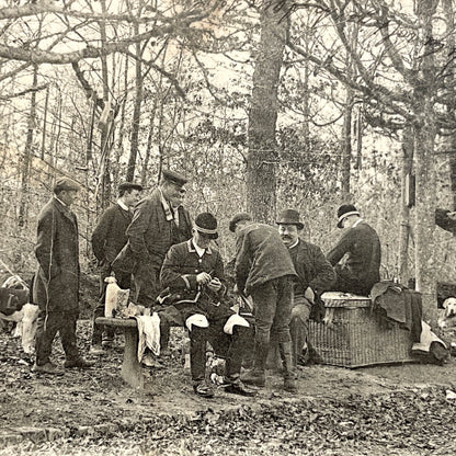 1900s French postcard showing huntsmen and a vintage bicycle having a picnic in Fontainebleau Forest.