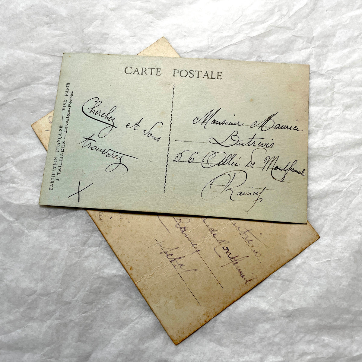 1910s French postcard lot with floral designs and a die-cut landscape scene of a village and church.